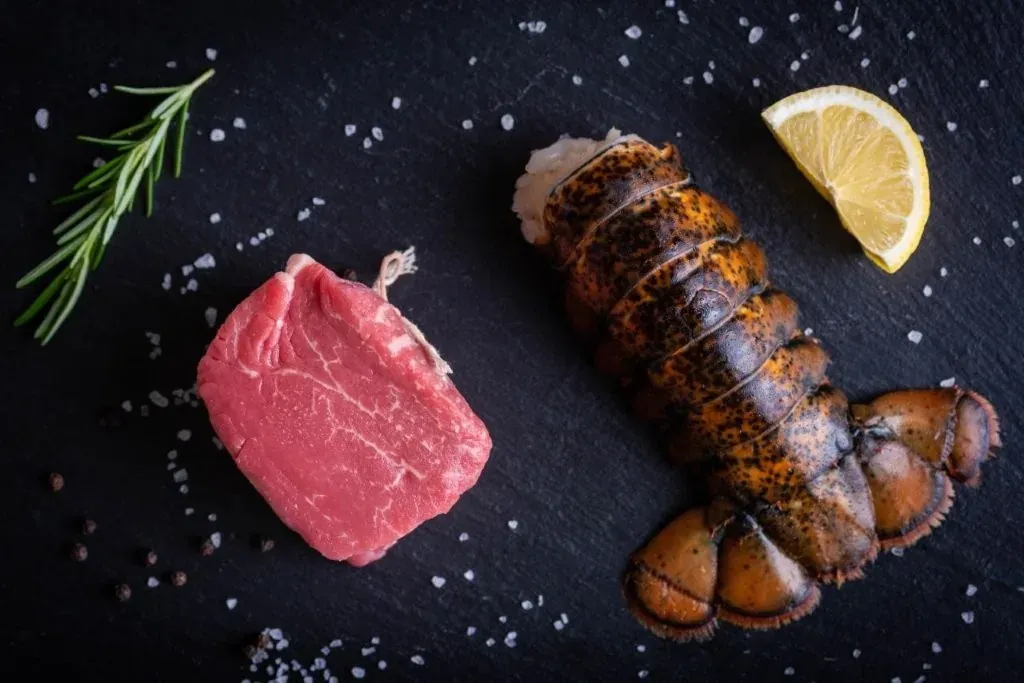 Filet mignon and lobster tail on slate, surf and turf
