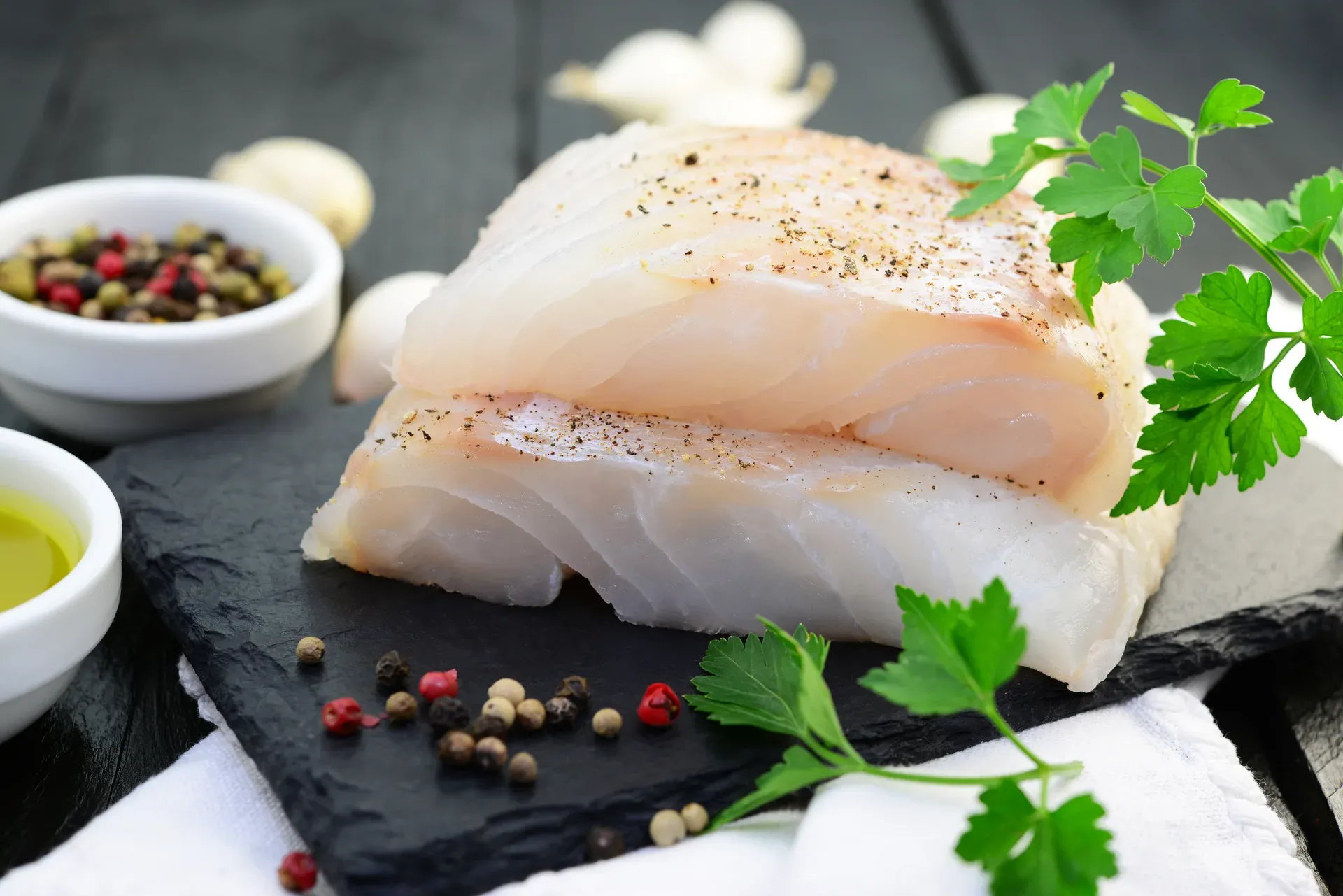 Raw halibut fillets on slate, Les Escoumins Fish Market