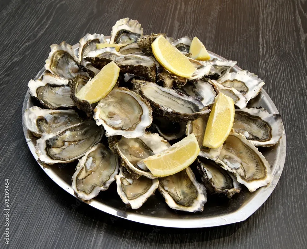 Platter of freshly shucked oysters with lemon, Les Escoumins Fish Market